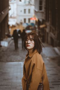 Woman standing on street in city