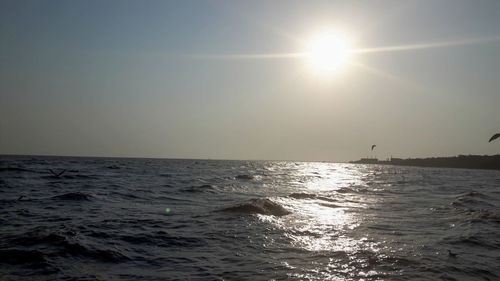 Scenic view of sea against sky on sunny day