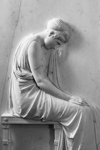 Low angle view of shirtless man sitting at beach