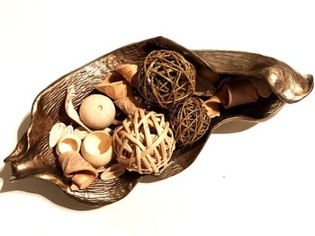 Close-up of eggs in basket against white background