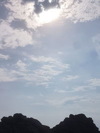 Low angle view of silhouette rocks against sky