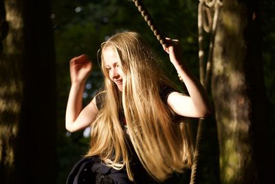 Portrait of young woman in tree