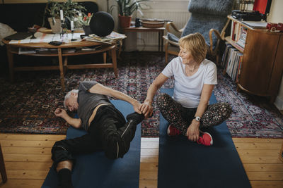 Senior couple doing yoga at home