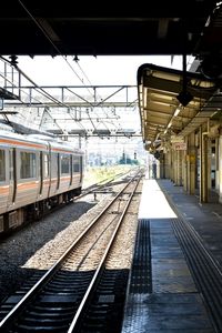 Train at railroad station platform against sky