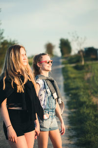 Friends standing on road in city