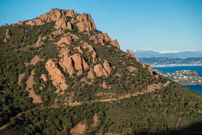 Scenic view of sea and mountains against clear sky