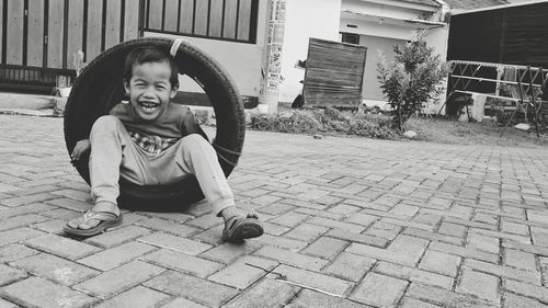 Portrait of kid sitting on street