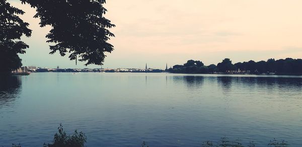 Scenic view of lake against sky at sunset