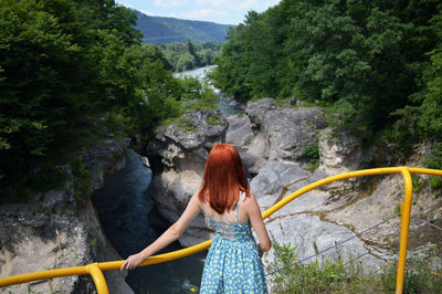 High angle view of woman standing at observation point against river