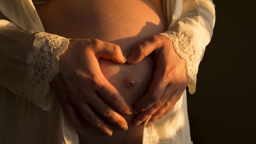 Midsection of woman touching fabric