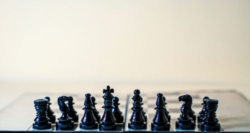 Close-up of chess pieces against white background