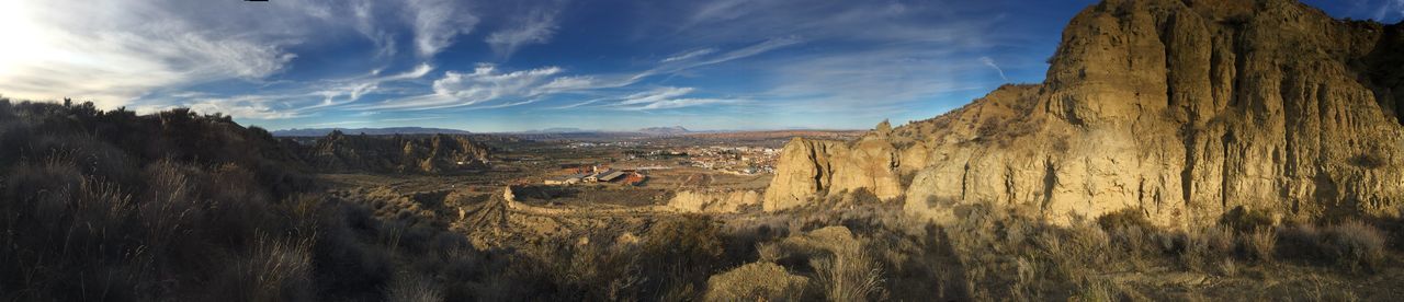 sky, tranquility, blue, tranquil scene, scenics, cloud - sky, nature, rock formation, beauty in nature, landscape, cloud, tree, rock - object, non-urban scene, day, sunlight, idyllic, panoramic, outdoors, remote