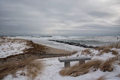 Scenic view of sea against cloudy sky during winter