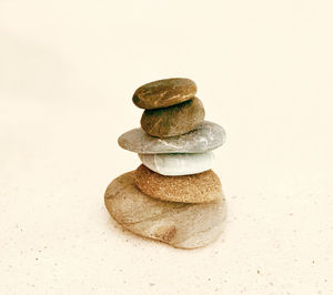 Close-up of stone stack against white background