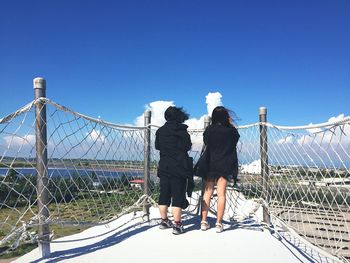 Full length of woman standing against clear sky