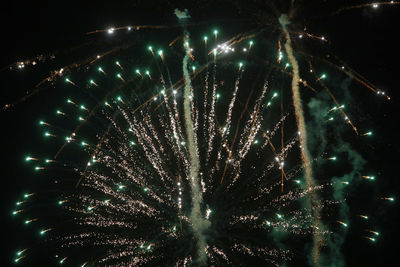 Low angle view of firework display at night