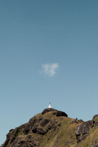 Low angle view of rock formation against sky