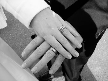 Cropped image of man and woman showing wedding rings