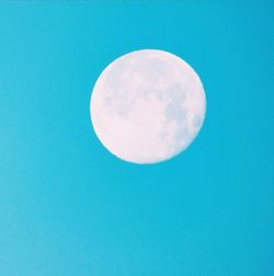 Low angle view of moon against clear blue sky