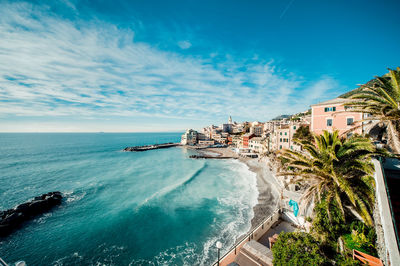 High angle view of cityscape by sea against sky