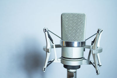 Close-up of microphone by wall