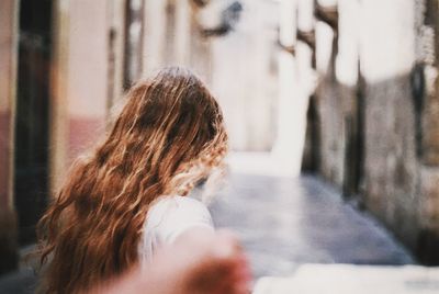 Rear view of girl on road