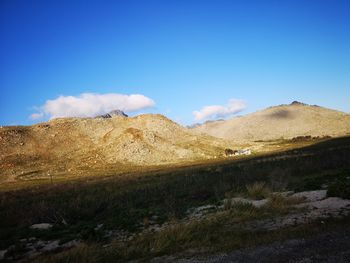 Scenic view of landscape against blue sky