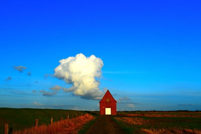 House on field against sky