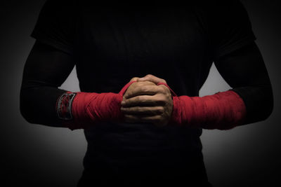 Close-up of man hand against black background