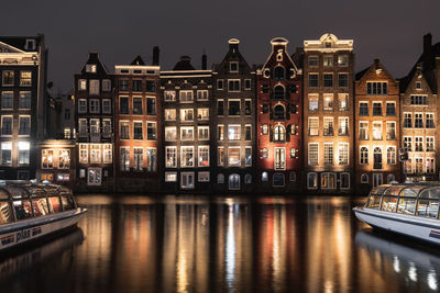 Reflection of buildings in city at night