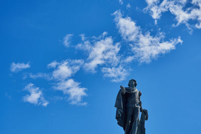 Low angle view of statue against blue sky