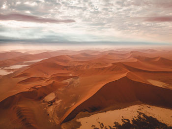 Scenic view of snowcapped mountains against sky during sunset