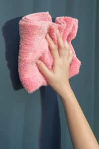 Midsection of woman holding pink flower