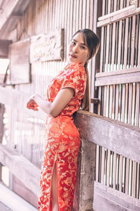 Woman standing by railing