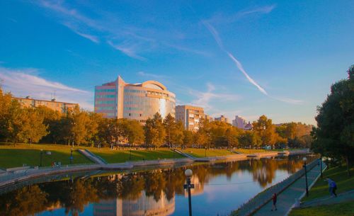 Reflection of trees and buildings in lake