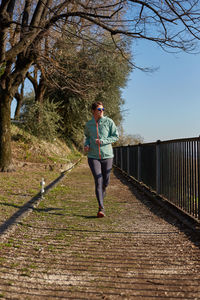 Full length of man standing on footpath