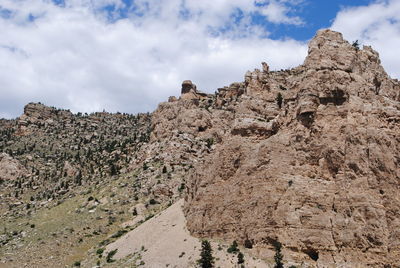 Low angle view of rock formation on land against sky