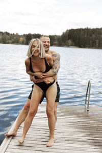 Happy couple standing on jetty