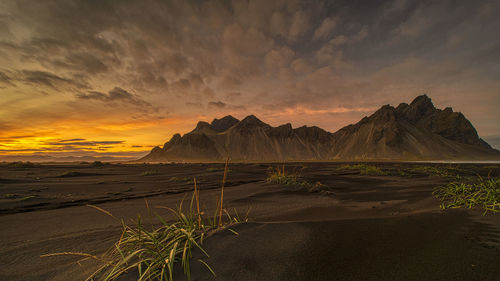 Scenic view of land against sky during sunset