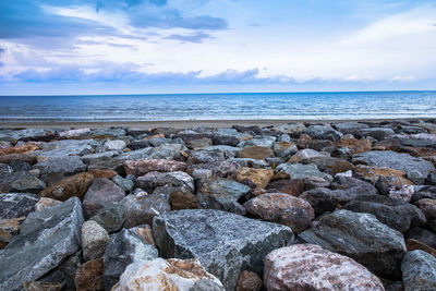 Scenic view of rocks in sea against sky