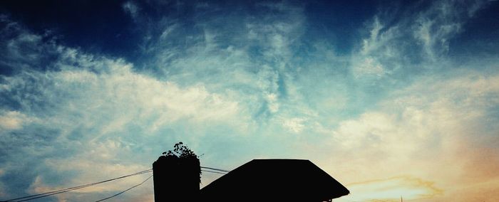 Low angle view of built structure against cloudy sky