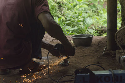 Low section of man working in workshop