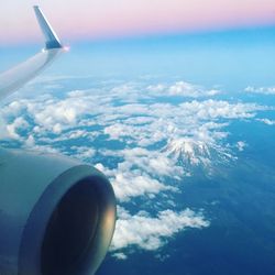 Aerial view of cloudscape over airplane wing