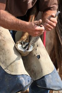 Farrier fitting horseshoe 