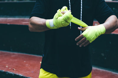 Midsection of man holding umbrella