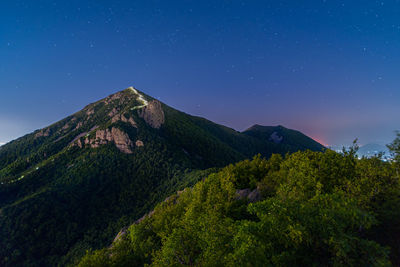 Scenic view of mountains against sky at night