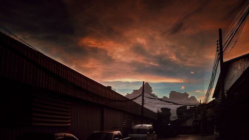 Low angle view of city against sky during sunset