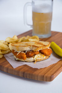 Close-up of breakfast and beer glass on cutting board 