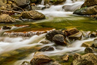 Scenic view of river flowing through rocks