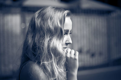 Portrait of young woman looking away outdoors